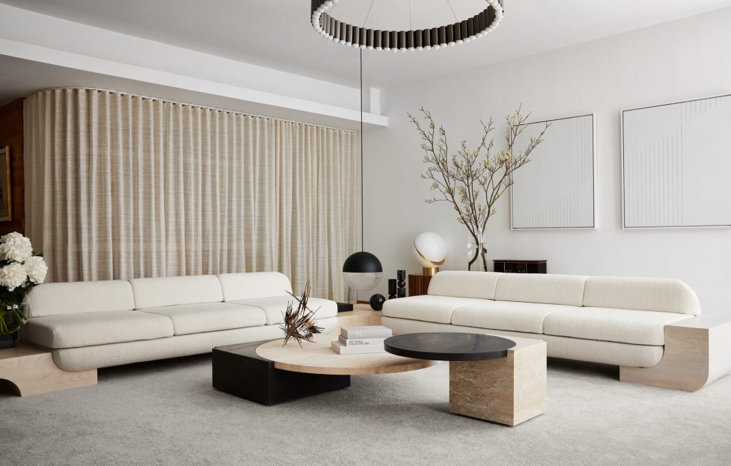 Luxury Living Room Sets - Comfy white and beige tones living room with two white sofas, a black and beige center table and a suspension lamp in black
