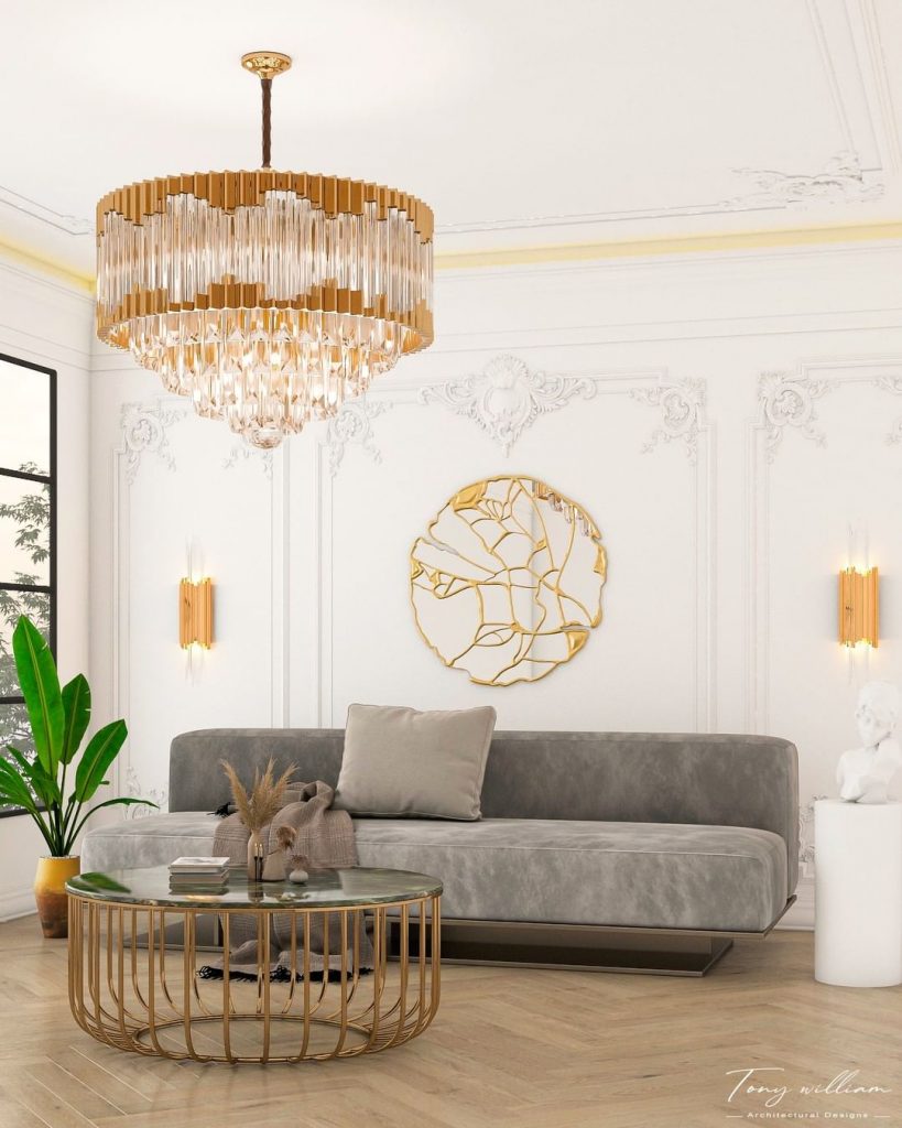 living room with grey sofa and round and gold coffee table