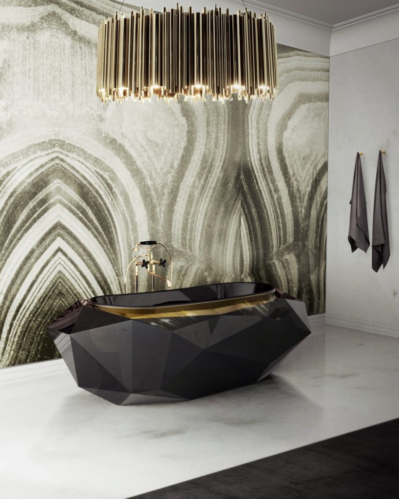 luxury bathroom with a black bathtub and a gold chandelier