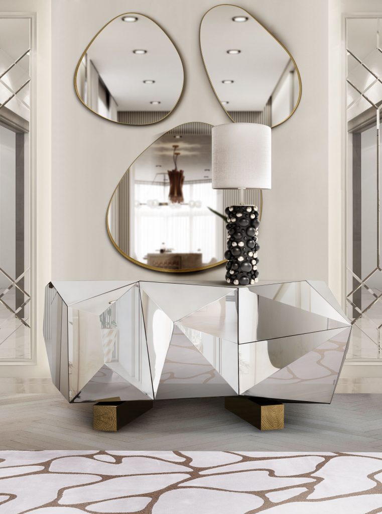 modern white entryway with luxury silver sidebaord, black and white lamp an mirror set